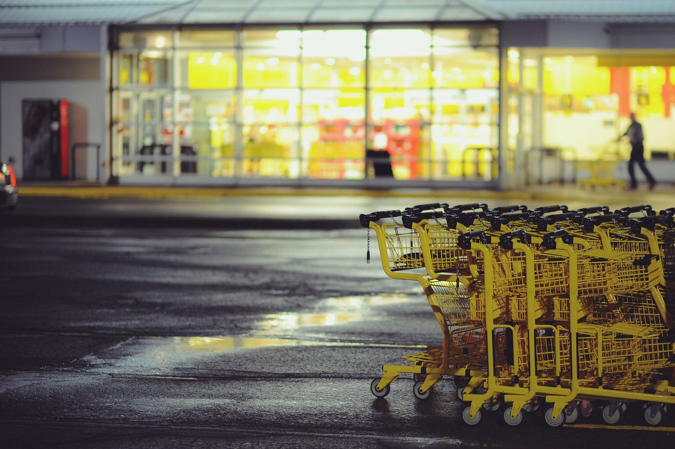 This is an image of yellow shopping carts outside of a store.