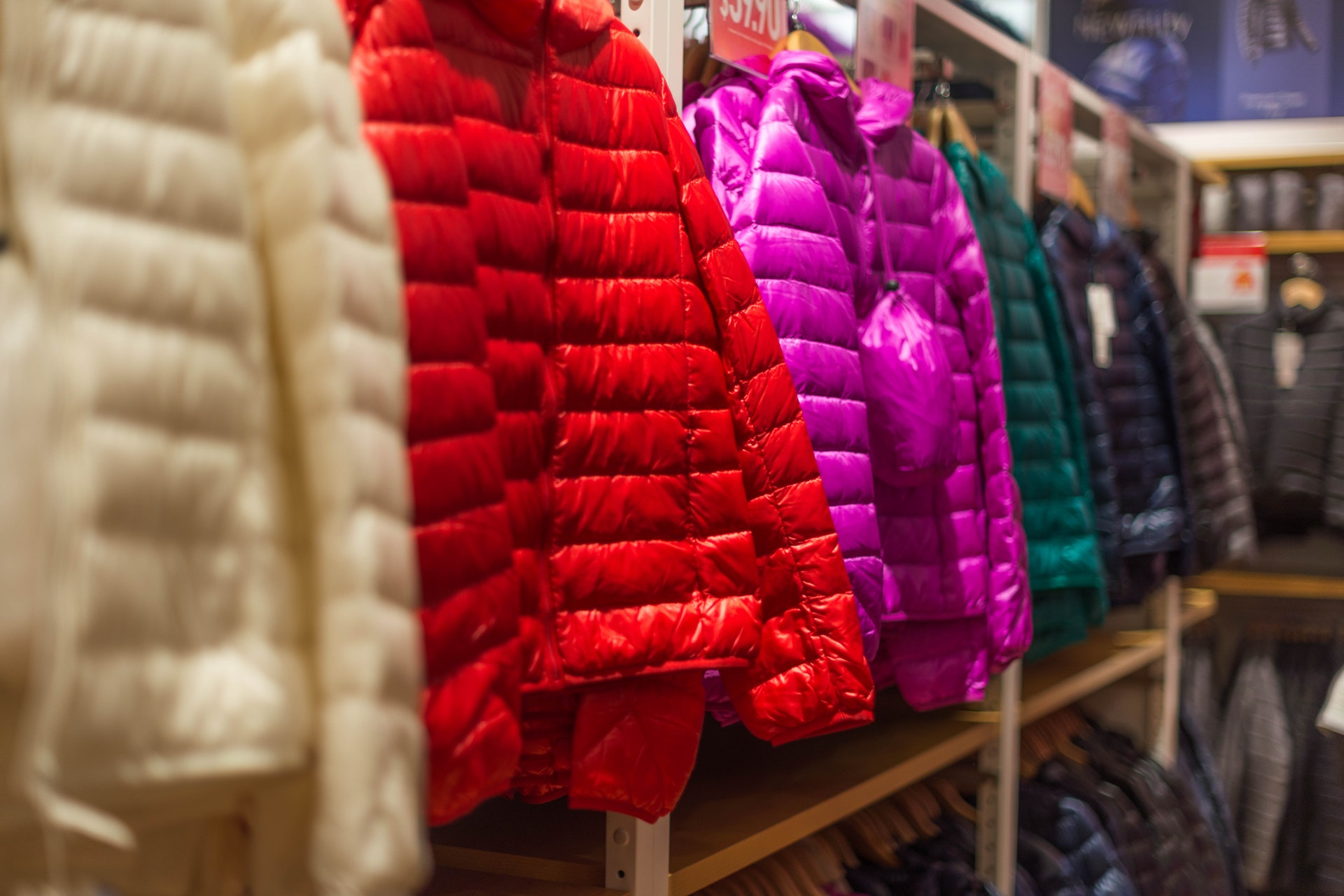 This is an image of colorful jackets at a retail store.