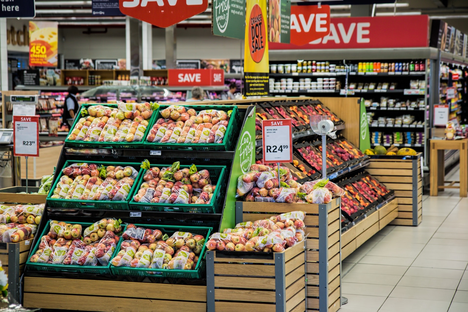 An image of fruit stands at a grocery store.