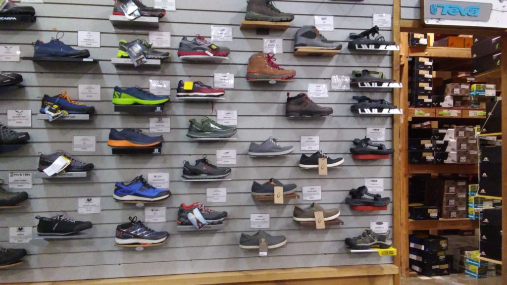 Footwear display on wall rack.