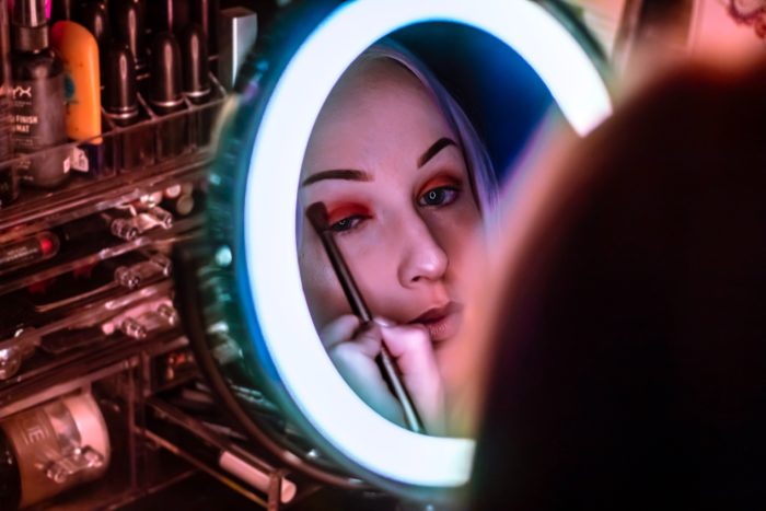 Woman applies eye makeup inside a store
