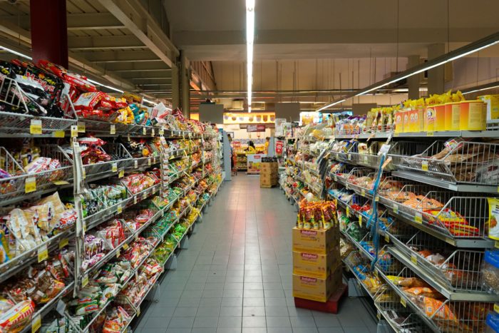 Grocery store aisle with stocked shelves